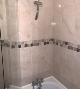 After of restored cream and black bathroom tiles in a residential property